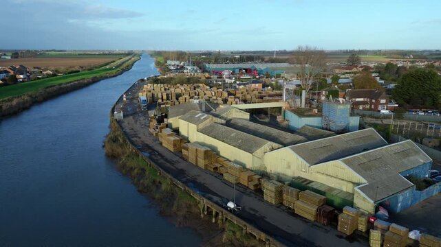 River Nene logistics aerial drone perspective of shipping channels and industrial wharf sites in Wisbech UK.
