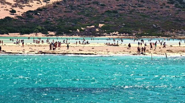 Relax at Balos Beach with turquoise waters and sandy shores, vibrant scene
