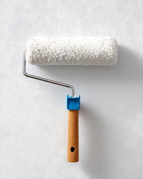 Paint Roller with Wooden Handle on White Textured Background