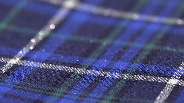 Closeup Macro Shot of Blue and Green Tartan Fabric with Glittering Threads.