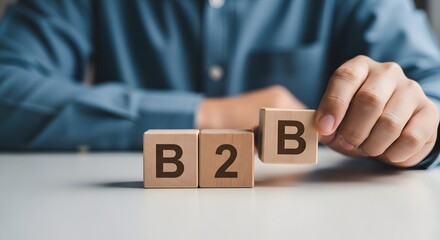 Naklejka premium Business to business marketing concept with wooden blocks on a table