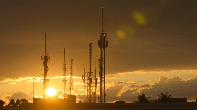 Telecommunication Towers At Golden Sunset Horizon