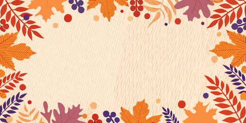 Autumn leaves and berries create a decorative frame on wood texture © Ganesh