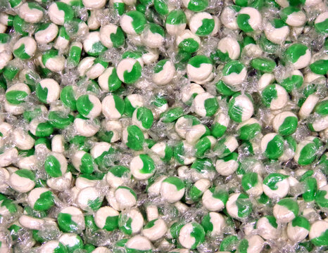 Pile of wrapped green and white candy