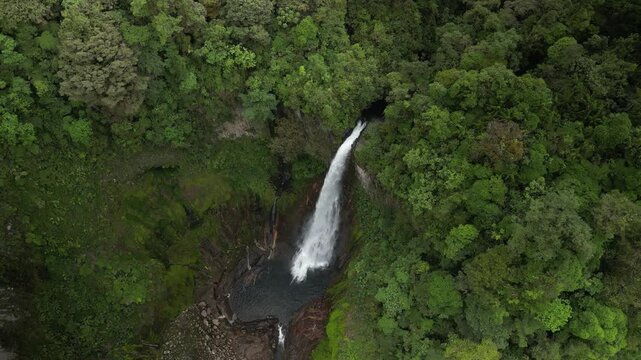 Close up aerial of Catarata del Toro waterfall in Costa Rica near bajos Del Toro in lush green rain forest steep hillsides