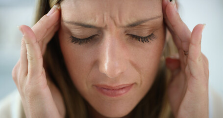 Naklejka premium Sick, headache and woman in home with pain, massage temples and financial crisis in living room. Stress, migraine and person in apartment with brain fog, bankruptcy and mental fatigue for debt
