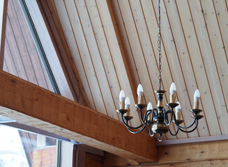 Wooden Chapel Ceiling with Classic Chandelier and Natural Light from Large Window