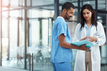 Doctor, nurse and reading folder in meeting for patient admission, medical report and information. People, team and consent form for surgery, healthcare checklist and treatment procedure at hospital