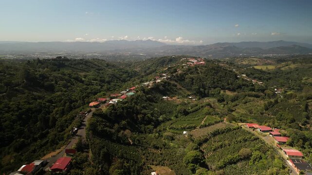 Aerial above steep and narrow hilltop town near Bajos Del Toro Costa Rica in lush tropical highlands