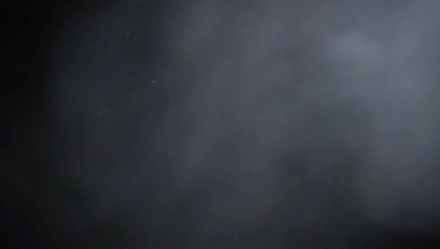 A dramatic video showcasing a mysterious cloud of smoke in a dark environment