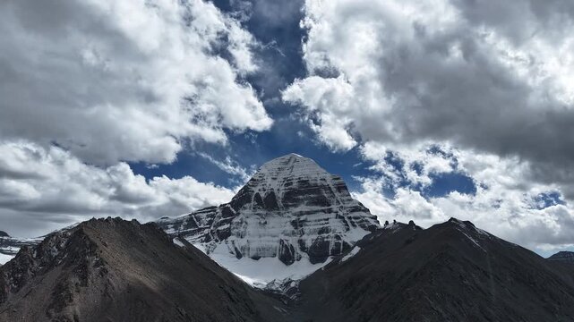 Aerial Cloud Timelapse Drone shot of Holy 𝗠𝗼𝘂𝗻𝘁 𝗞𝗮𝗶𝗹𝗮𝘀𝗵 peak and rugged landscape in Tibet, spiritual Himalaya pilgrimage 4K