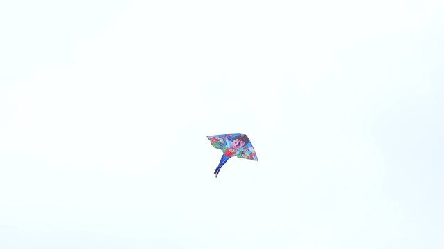Colorful Kite Flying in Clear Blue Sky