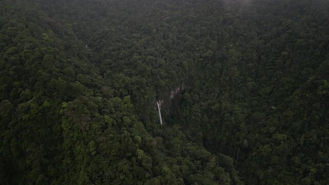 High aerial above hidden waterfall Quebrada Gata in Costa Rica near Bajos del toro