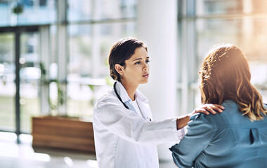Obraz premium Woman, doctor and comfort with talk at hospital for bad news, diagnosis and counseling for wellness. People, patient and medical professional with consultation, discussion and support at clinic