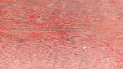 Close-Up Detail of Distressed Red Wooden Surface. Macro view of scratched and worn red painted wood texture. Strong abstract rustic background