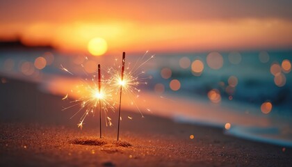 Obraz premium Two sparklers burn on a sandy beach during sunset. The ocean waves and warm sky create a bokeh effect. Lights glitter on the wet sand near the shore.
