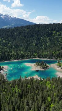 Lake Cauma turquoise color water alpine highlands nature, aerial drone vertical video Switzerland