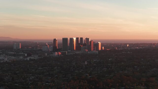 Aerial wide panning shot of Century City at golden hour in Los Angeles, California. 4K