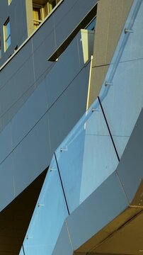 Close up of a contemporary buildings glass railing and aluminum panels. Ideal for architectural design, urban development, and real estate marketing videos.