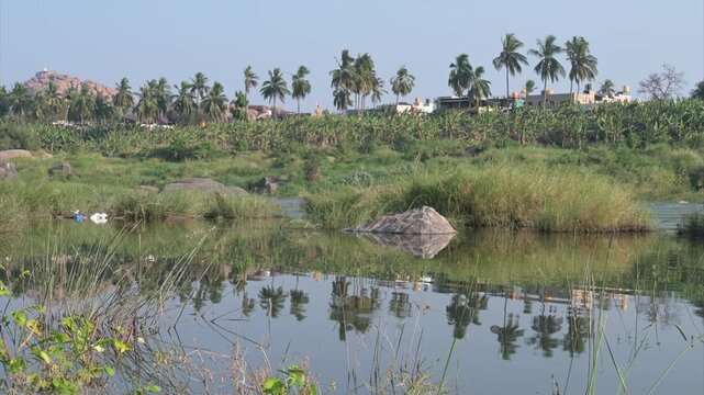 Hampi landscape, Tungabhadra river with boulders, view from Hippie island, nature of South India, Karnataka, travel destination