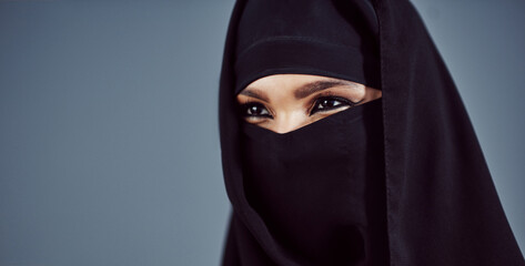 Naklejka premium Niqab, space and thinking with muslim woman in studio for religion, Ramadan Kareem and arabic culture. Eid Mubarak, vision and inspiration with person and hijab on gray background for reflection