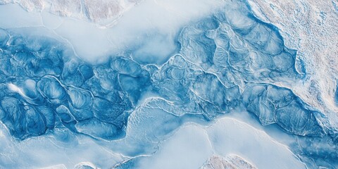 Fototapeta premium Abstract aerial view of frozen water patterns and icy textures in cool blue tones