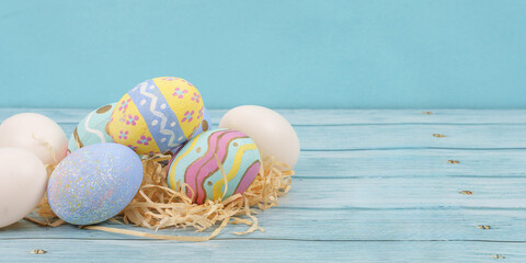 Fototapeta premium Easter eggs and decorations on wooden background