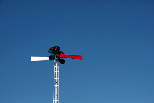 Part of old railway signal under blue sky