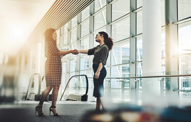 Obraz premium Introduction, handshake or businesswomen in agency with tablet, greeting or meeting for b2b deal. Networking, flare or employees in office with tech, collaboration or opportunity for partnership.