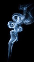 Obraz premium Elegant blue smoke swirls gracefully against a stark black background, creating abstract art