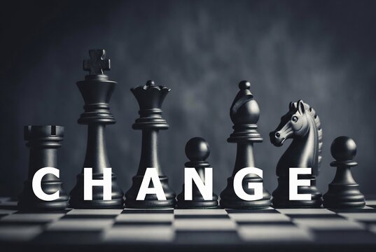 Chess pieces arranged with the word &ldquo;CHANGE&rdquo; overlaid on a chessboard.