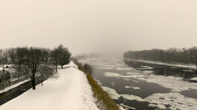 Aerial ascend of snowfall close to Connecticut river in Northampton USA