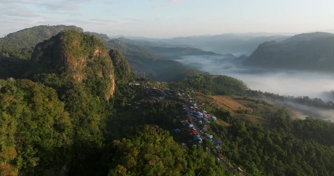 Ban Jabo Village In Limestone Mountains, Overlooking Morning Mist in Pang Ma Pha, Thailand. aerial shot