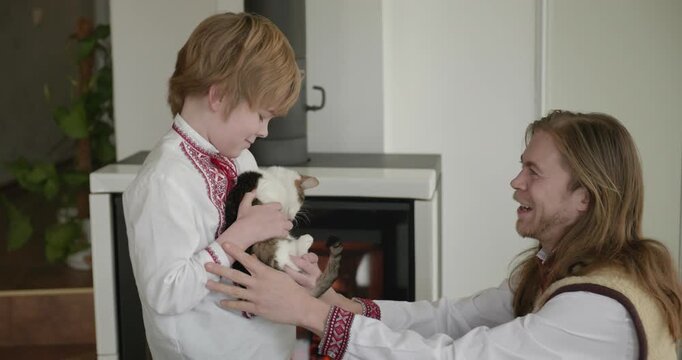 Man Talk with Kid Boy Holding Cat Kitten. Happy Family Father Dad Son Relations Childhood. 4K 10-bit