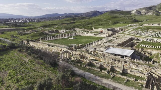Cinematic aerial drone video of Tripolis Antik Kenti near Buldan in Denizli, Turkey, featuring Roman ruins, columns, stone structures, and panoramic scenic landscape from above.
