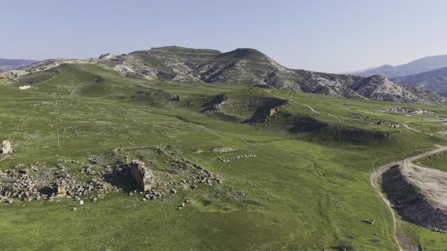 Cinematic aerial drone video of Tripolis Antik Kenti near Buldan in Denizli, Turkey, featuring Roman ruins, columns, stone structures, and panoramic scenic landscape from above.