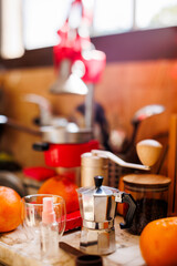 Ingredients for making coffee. Moka pot, bean spray, coffee grinder with coffee beans standing on the kitchen table.