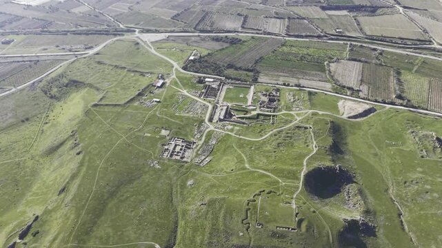 Cinematic aerial drone video of Tripolis Antik Kenti near Buldan in Denizli, Turkey, featuring Roman ruins, columns, stone structures, and panoramic scenic landscape from above.