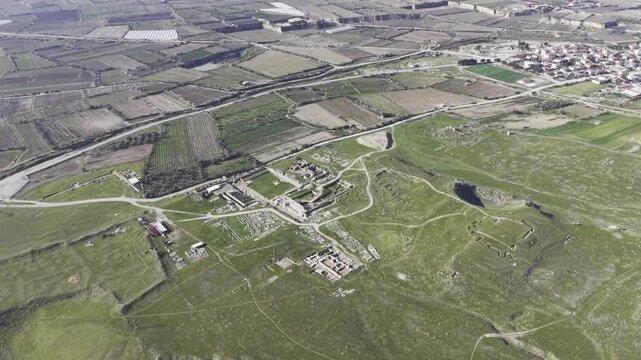 Cinematic aerial drone video of Tripolis Antik Kenti near Buldan in Denizli, Turkey, featuring Roman ruins, columns, stone structures, and panoramic scenic landscape from above.