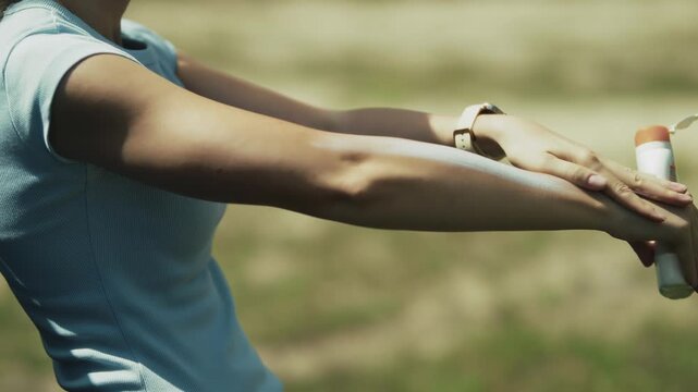 Applying Sunscreen Lotion On Arm. Protecting Skin From UV Rays During Summer Training