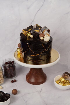 Elegant Coco Gold Tall Cake featuring multiple layers of rich chocolate sponge with creamy frosting and luxurious decoration. This tall celebration cake stands out with its premium presentation and in