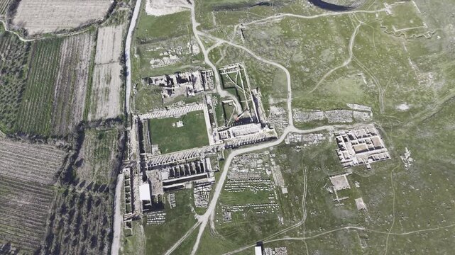 Cinematic aerial drone video of Tripolis Antik Kenti near Buldan in Denizli, Turkey, featuring Roman ruins, columns, stone structures, and panoramic scenic landscape from above.
