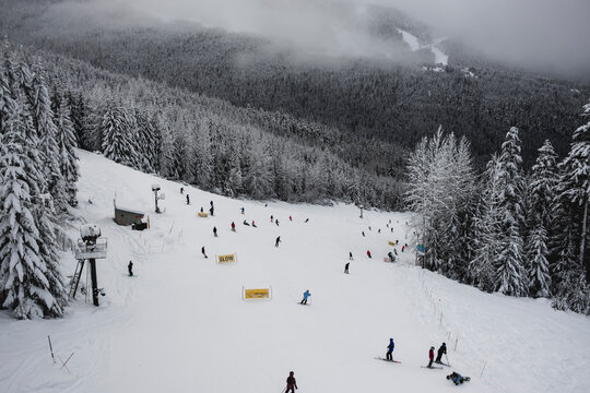 View of ski run with lots of skiers at Whistler Blackcomb