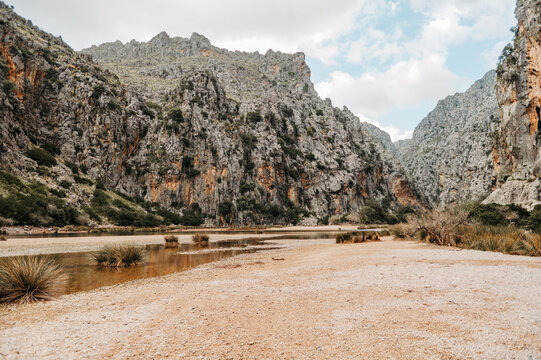 Shallow river and sandy riverbed in Torrent de Pareis gorge, Mallorca
