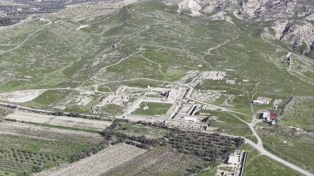 Cinematic aerial drone video of Tripolis Antik Kenti near Buldan in Denizli, Turkey, featuring Roman ruins, columns, stone structures, and panoramic scenic landscape from above.