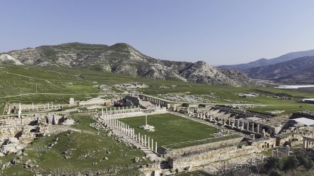 Cinematic aerial drone video of Tripolis Antik Kenti near Buldan in Denizli, Turkey, featuring Roman ruins, columns, stone structures, and panoramic scenic landscape from above.