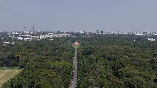 Aerial view of long road amid large trees leading to memorial hall in Cubbon Park