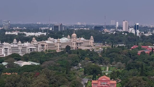 Aerial view of Vidhana Soudha government building surrounded by lush trees in Bengaluru