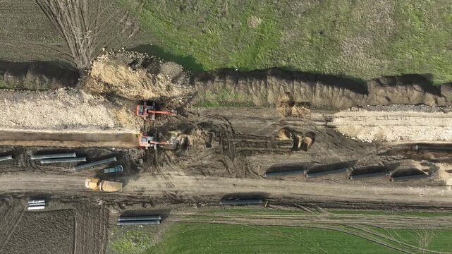 Aerial view of gas and oil pipeline construction. Pipes welded together. Big pipeline is under construction.
