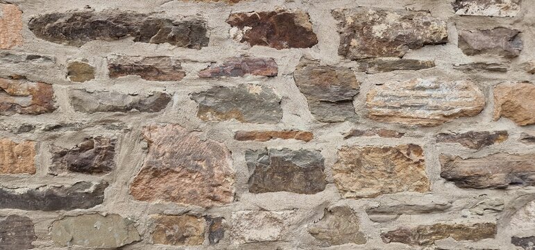 A medieval wall made of uneven stones arranged in a structured pattern